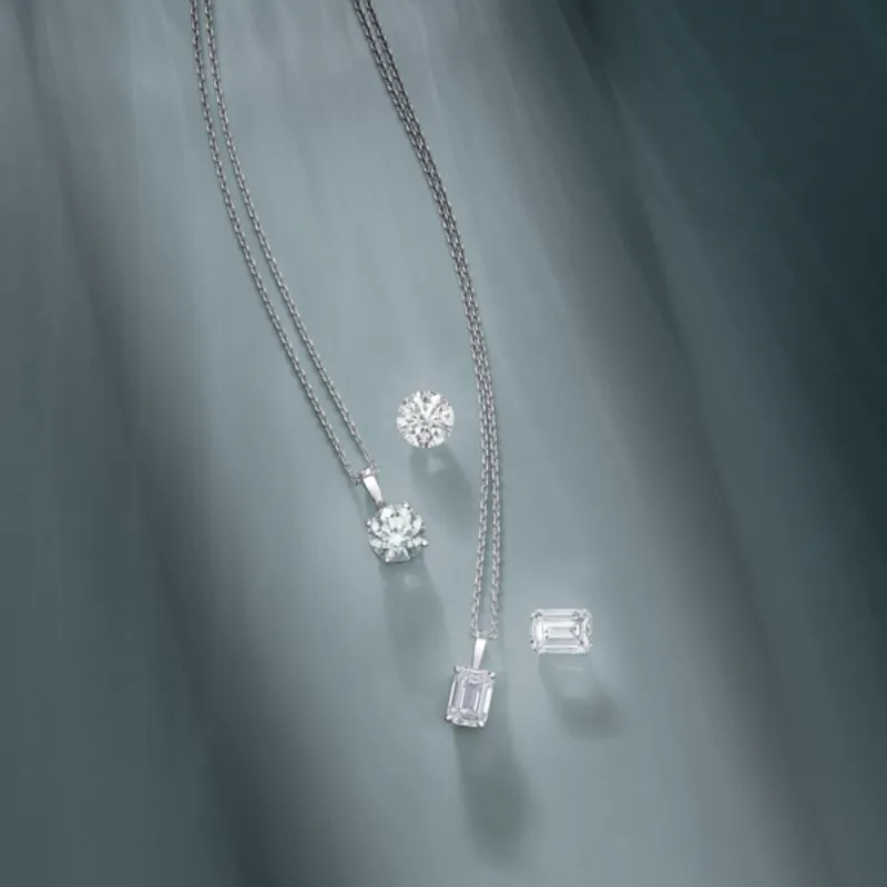 Timeless diamond solitaire pendant necklaces and loose emerald and round diamonds.
