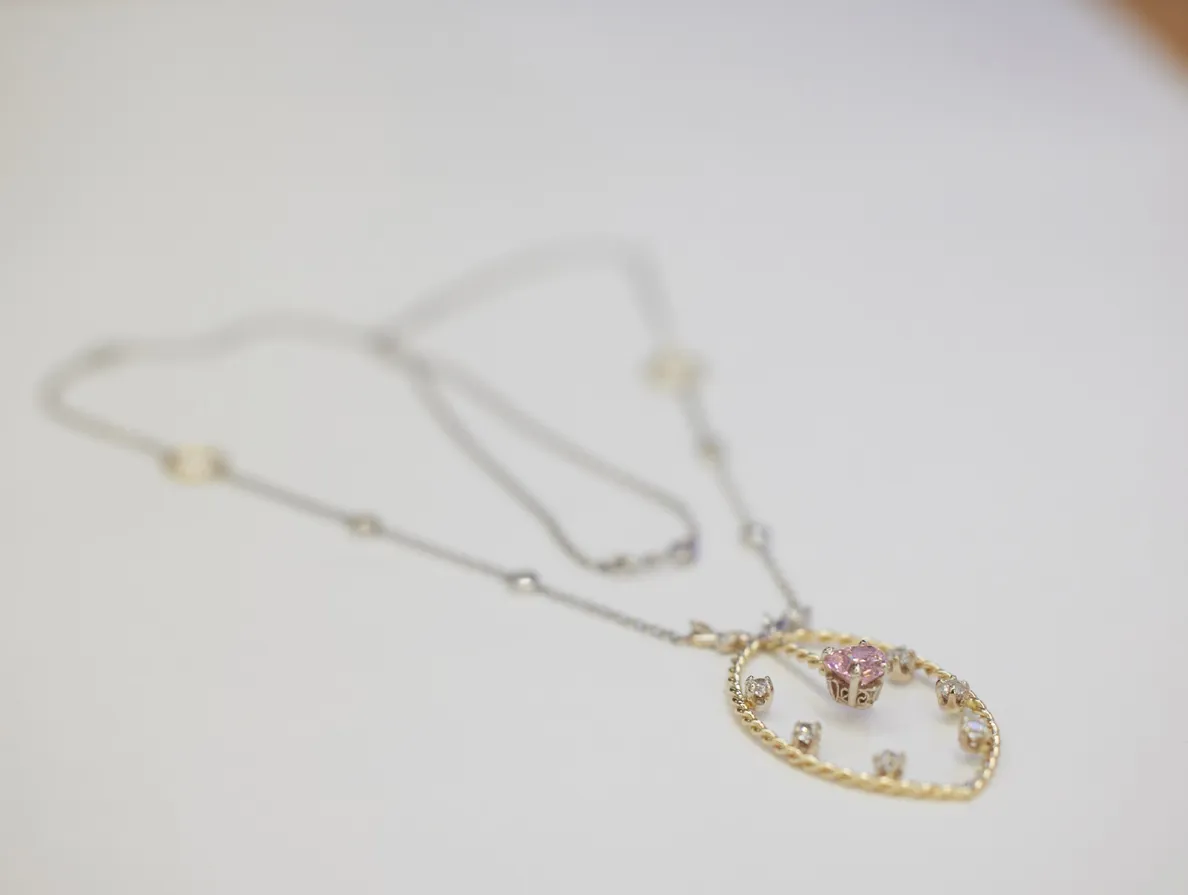 Gold necklace with pink gemstone and diamonds | Jewelry Reimagining available at Raleigh Diamond Fine Jewelry Raleigh, NC