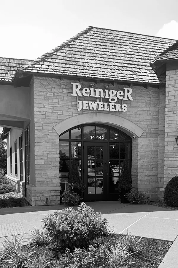 A hand holding a diamond ring on a ring sizer, measuring size 17. Visit Reiniger Jewelers for fine jewelry.