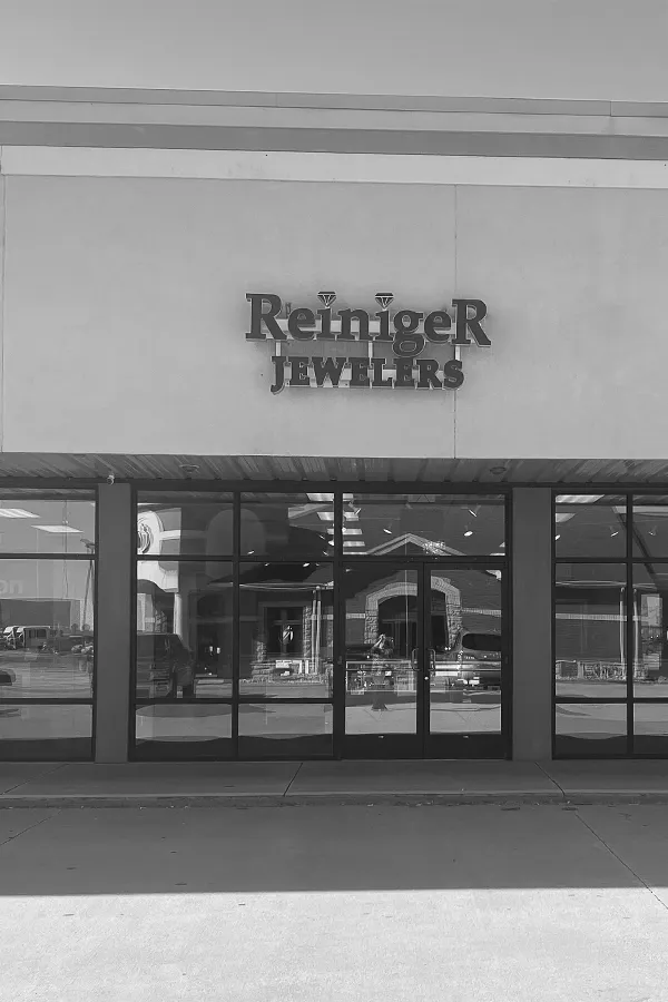 A hand holding a diamond ring on a ring sizer, measuring size 17. Visit Reiniger Jewelers for fine jewelry.