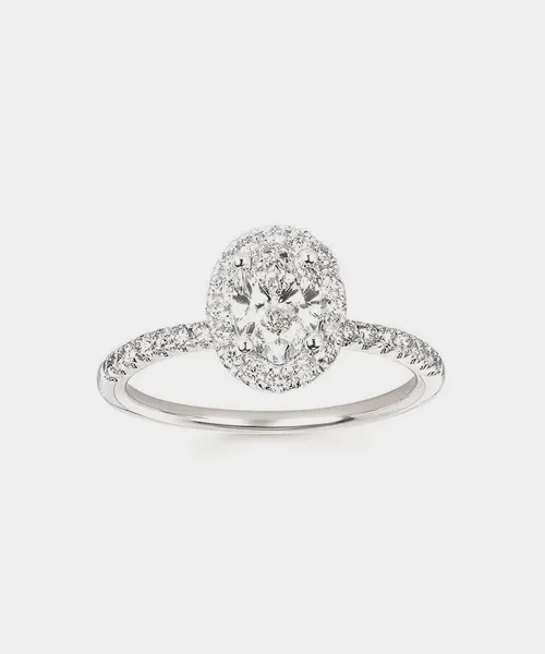 Elegant lab diamond engagement ring with a halo setting and a delicate band, showcased by Reiniger Jewelers.