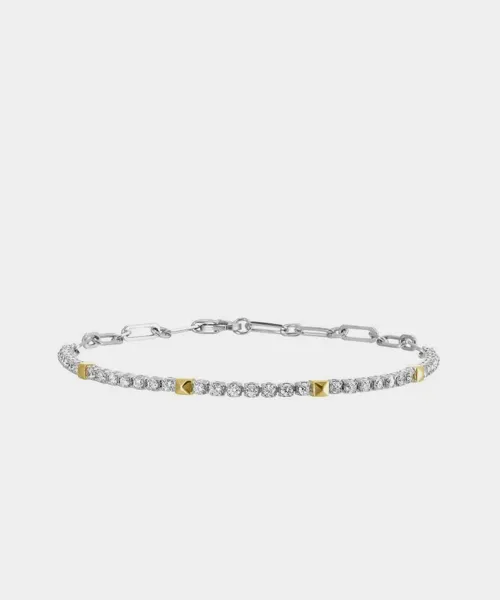 Silver bracelet with diamond accents and gold pyramid details, showcasing elegance and style. Visit Reiniger Jewelers.