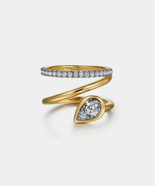 Gold spiral ring with a pear-shaped diamond and a row of smaller diamonds. Shop at Reiniger Jewelers for fine jewelry.