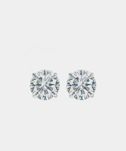 Round diamond stud earrings set in silver, showcasing brilliance and elegance. Perfect for any occasion.