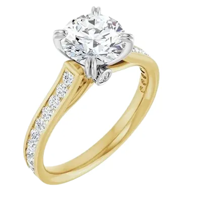 Elegant yellow gold engagement ring with a large diamond and smaller diamonds on the band. Shop at Renzo & Co. in Charlotte.