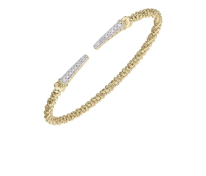 Gold cuff bracelet with diamond accents, perfect for gifting.
