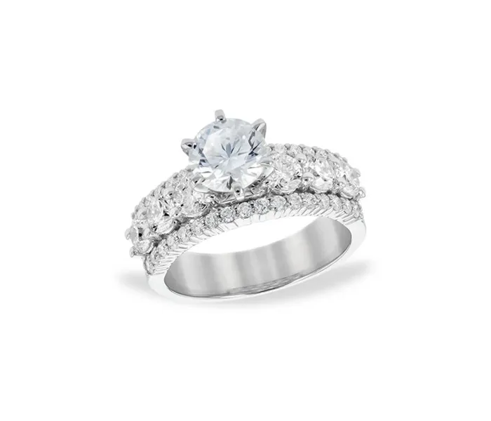 Elegant silver engagement ring with a large center stone and intricate side detailing.