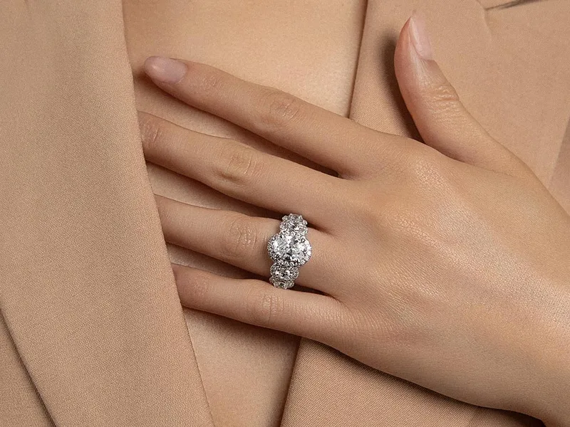 Elegant diamond engagement ring on a hand, showcasing fine jewelry.