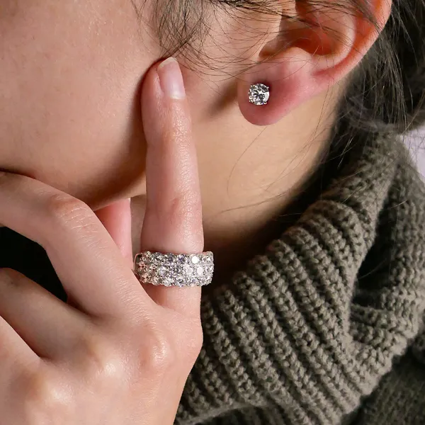 Model showcasing a sparkling ring and stud earrings.