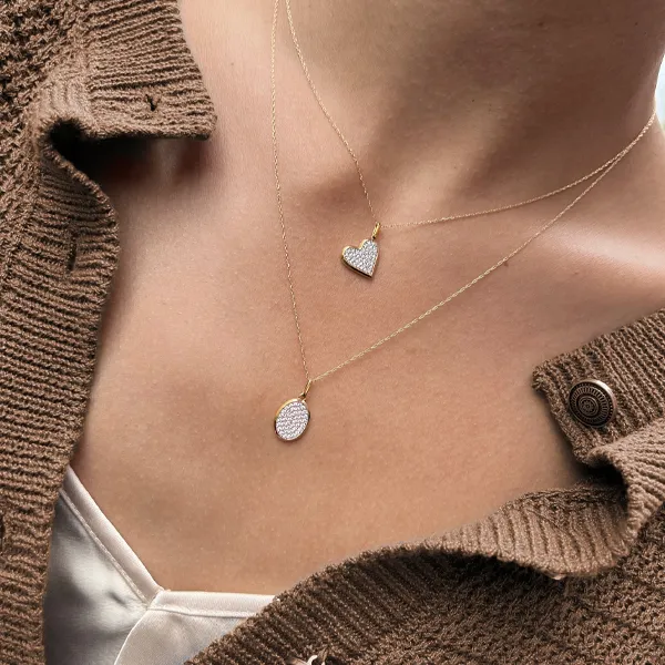 Gold necklace with a turquoise pendant, adorned with diamonds, displayed for R. Gregory Jewelers in Statesville. Shop now!