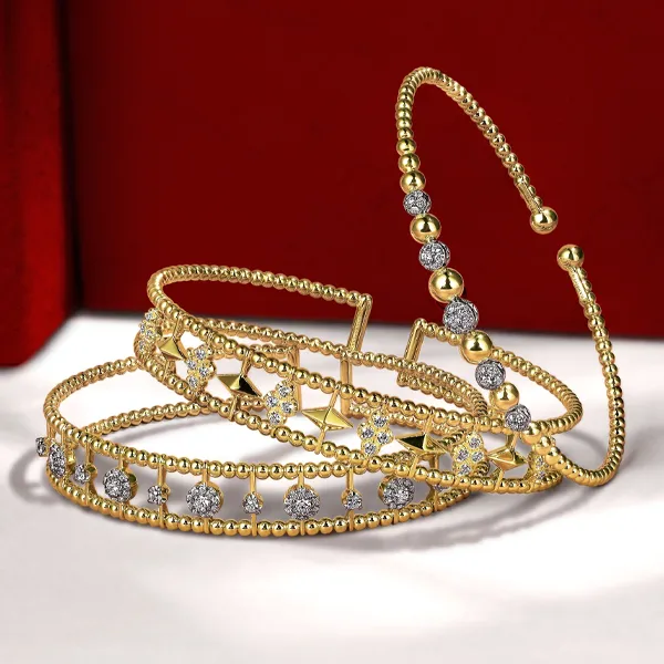 Elegant gold and silver bracelets displayed. Click to explore more bracelets at R. Gregory Jewelers.