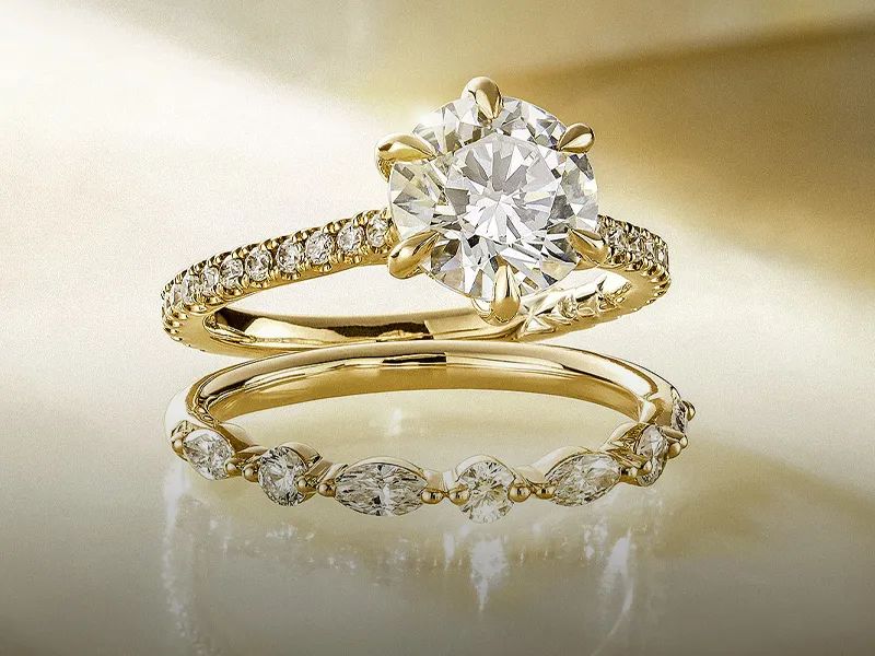Elegant gold engagement and wedding rings with sparkling diamonds.
