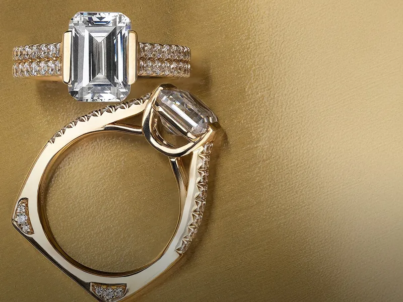 Elegant diamond engagement rings displayed on a gold surface. Click to explore more diamonds at R. Gregory Jewelers.