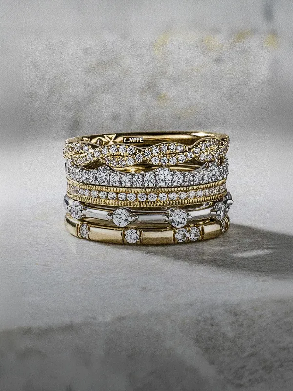 Stylish gold and silver wedding bands stacked together, available at R. Gregory Jewelers.