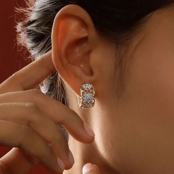 Sparkling diamond hoop earrings worn by a model. Click to explore more earrings at R. Gregory Jewelers.
