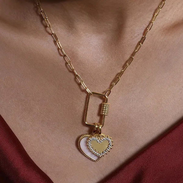 Gold heart pendant necklace with sparkling details, available at R. Gregory Jewelers. Click to explore more necklaces.