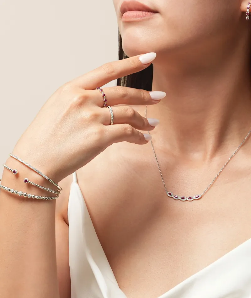 Model showcasing elegant jewelry, including rings, bracelets, and a necklace. Visit R. Gregory Jewelers in Statesville.