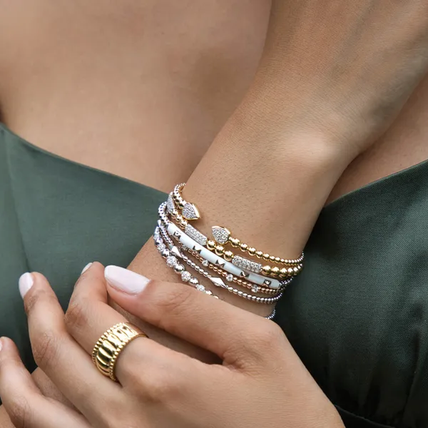 Elegant gold and silver bracelets displayed. Click to explore more bracelets at R. Gregory Jewelers.