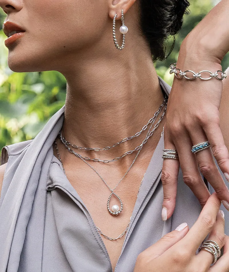 Model showcasing elegant jewelry, including rings, bracelets, and a necklace. Visit R. Gregory Jewelers in Statesville.