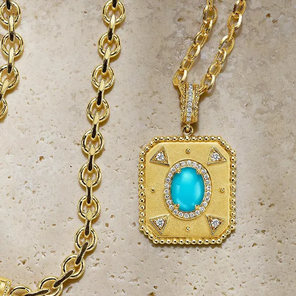 Gold necklace with a turquoise pendant, adorned with diamonds, displayed for R. Gregory Jewelers in Statesville. Shop now!
