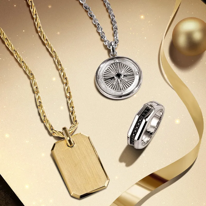 Elegant gold and silver jewelry featuring a pendant, compass necklace, and a ring, showcasing fine craftsmanship.