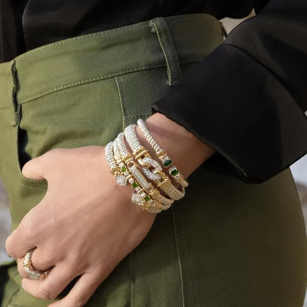 Elegant gold and silver bracelets on a wrist. Click to explore more bracelets at R. Gregory Jewelers.