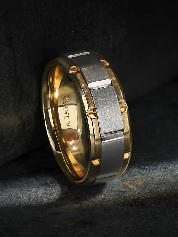 Stylish gold and silver wedding band with a modern design, available at R. Gregory Jewelers.