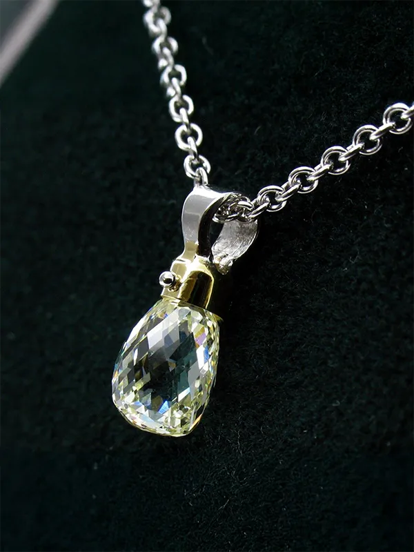 Elegant gemstone pendant on a silver chain, showcasing intricate design. Click to explore more at Rich Custom Jewelry.