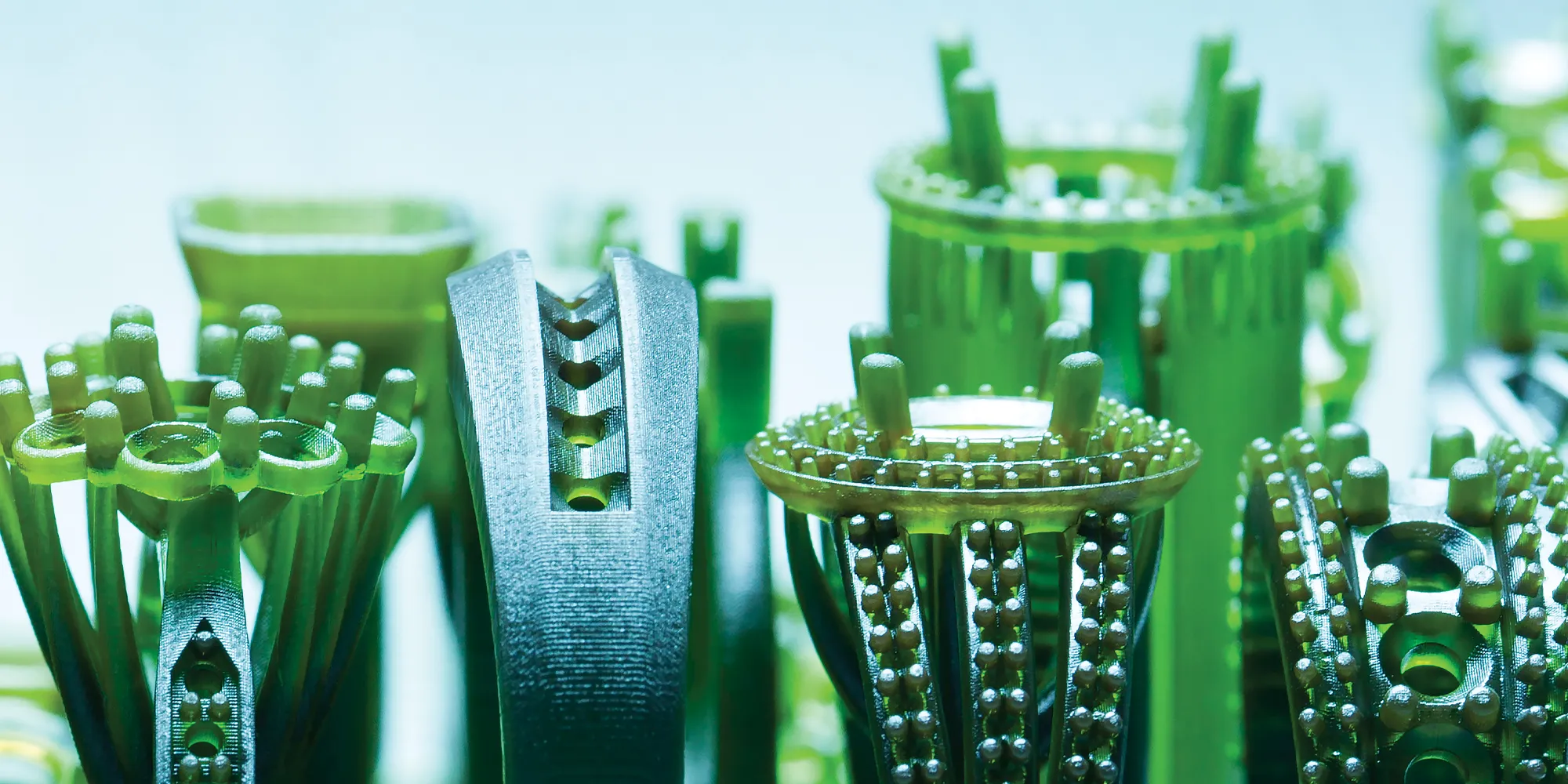 Close-up of intricate green jewelry designs, showcasing detailed craftsmanship at Rich Custom Jewelry in Las Vegas.