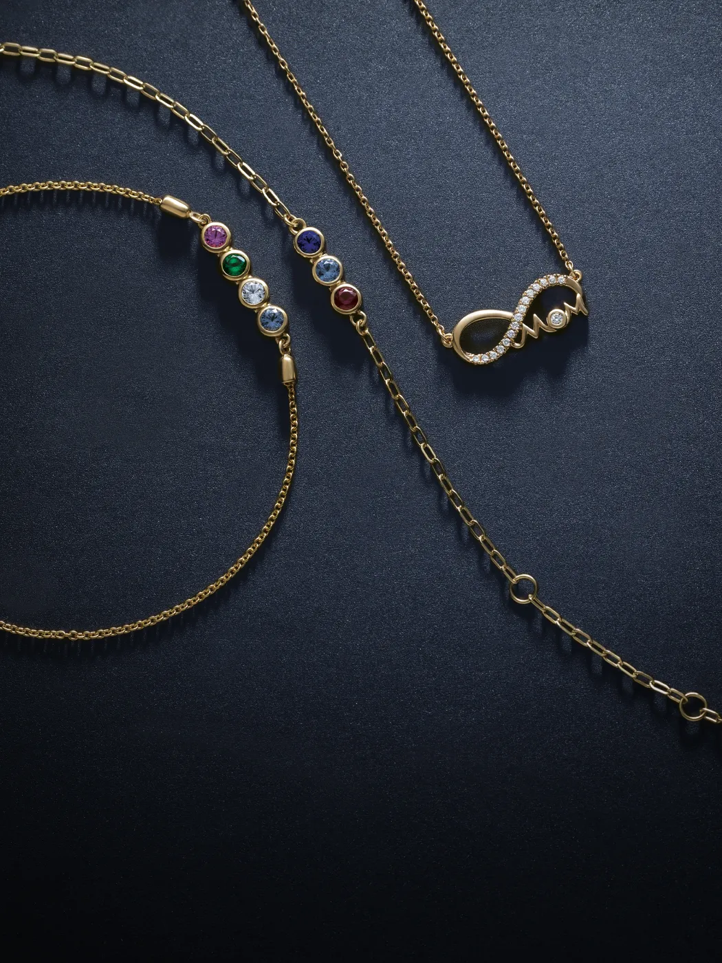 Gold necklaces with colorful birthstones and an infinity 