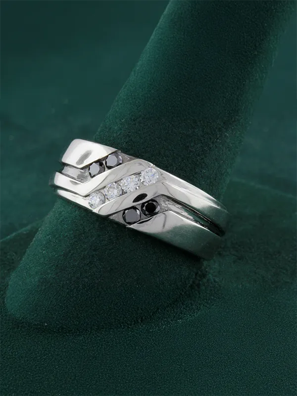 Gold diamond ring with intricate design featuring multiple sparkling stones, displayed on a green velvet stand.