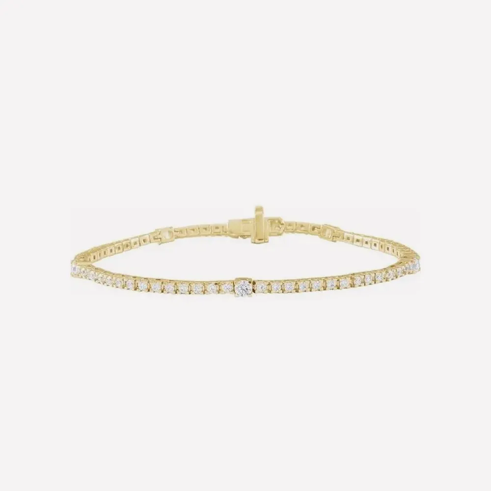 Gold tennis bracelet with diamonds on a white background. Click to explore Tennis Bracelets.