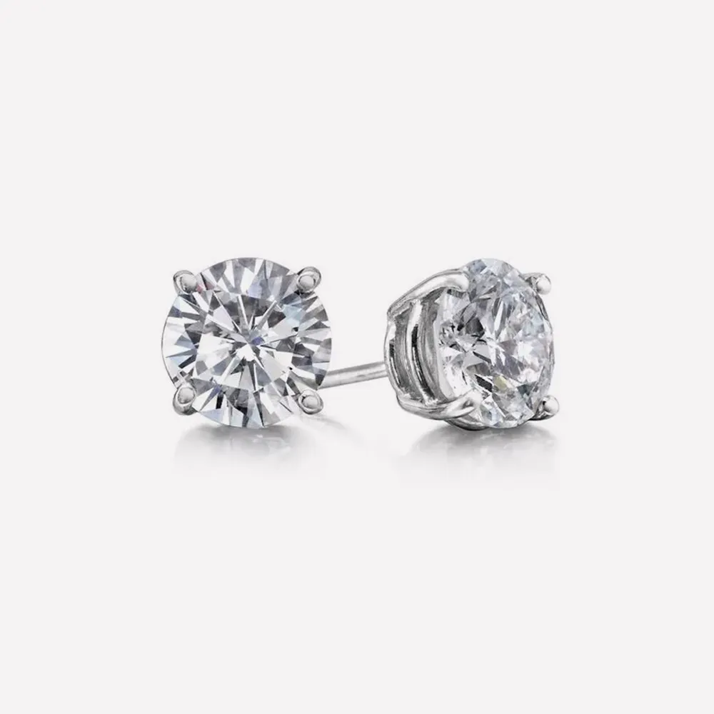 Diamond stud earrings with silver prongs on a white background. Click to view Diamond Studs.