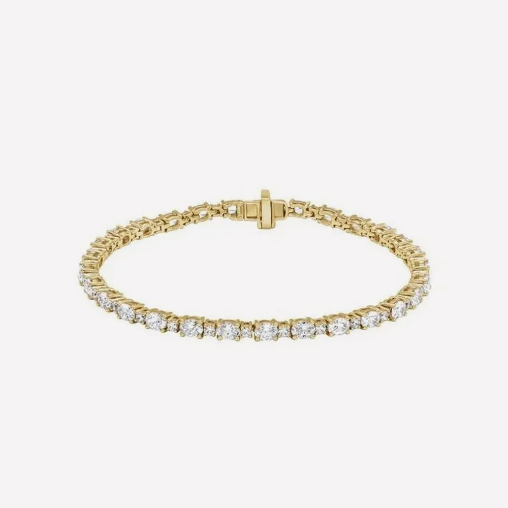 Gold bracelet with diamonds on white background. Click to explore bracelets.