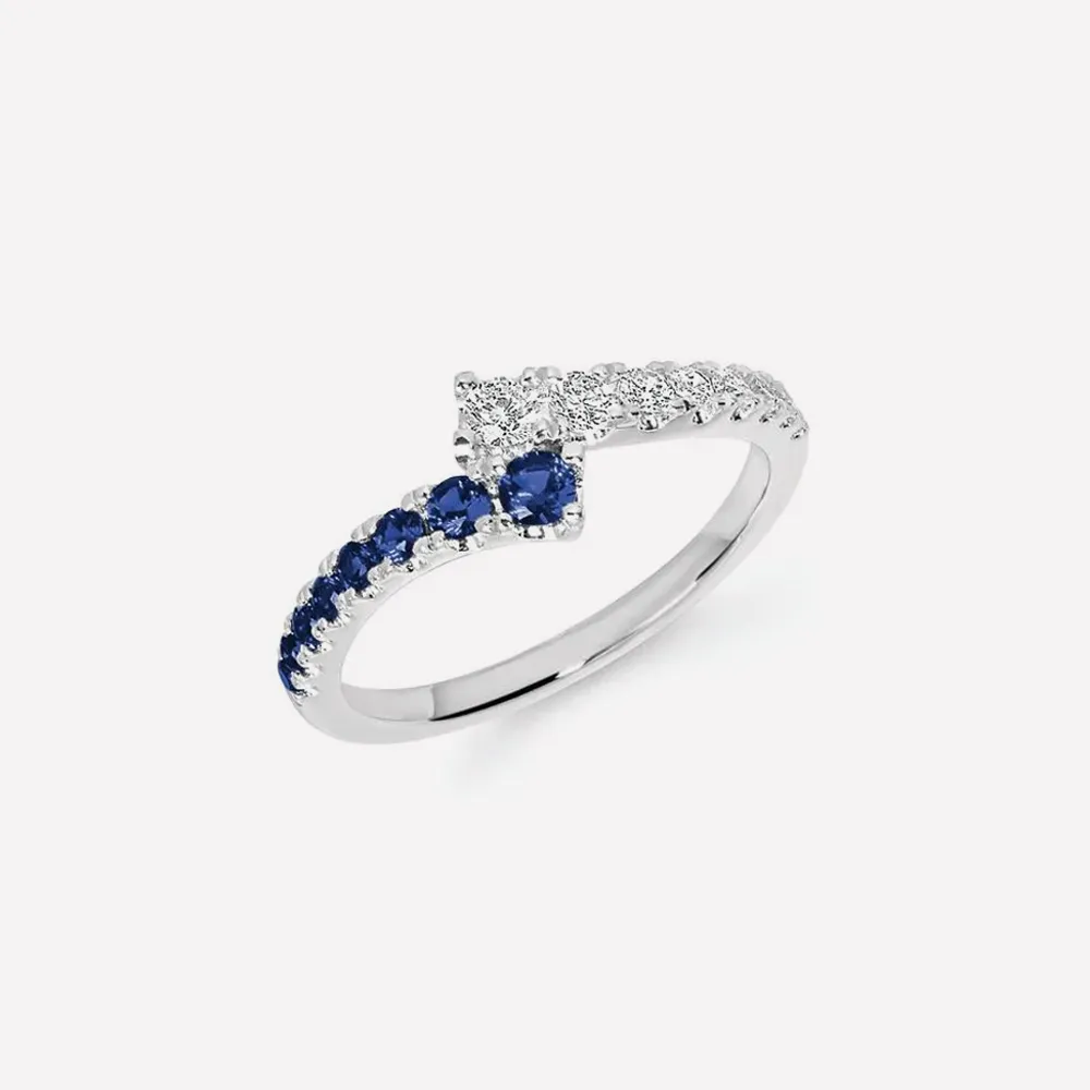 Elegant ring with blue sapphires and diamonds on a white background. Explore more rings.