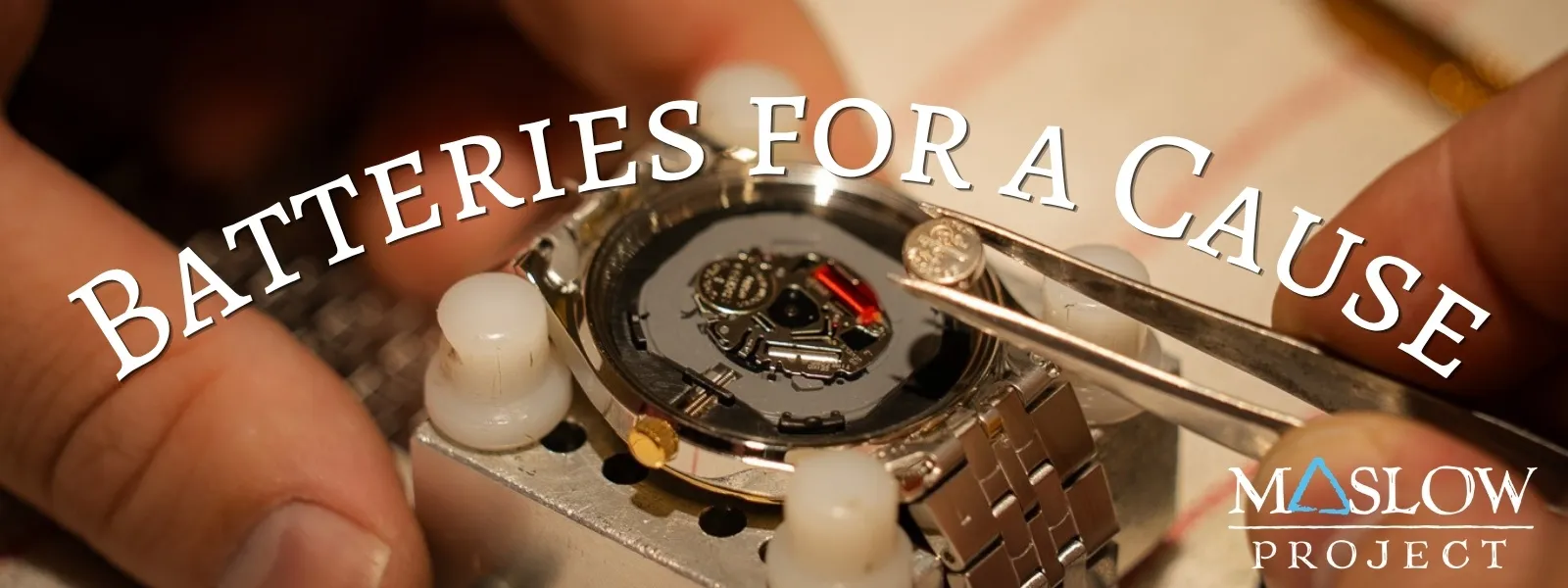 A person uses tweezers to insert a battery into a watch, with text 