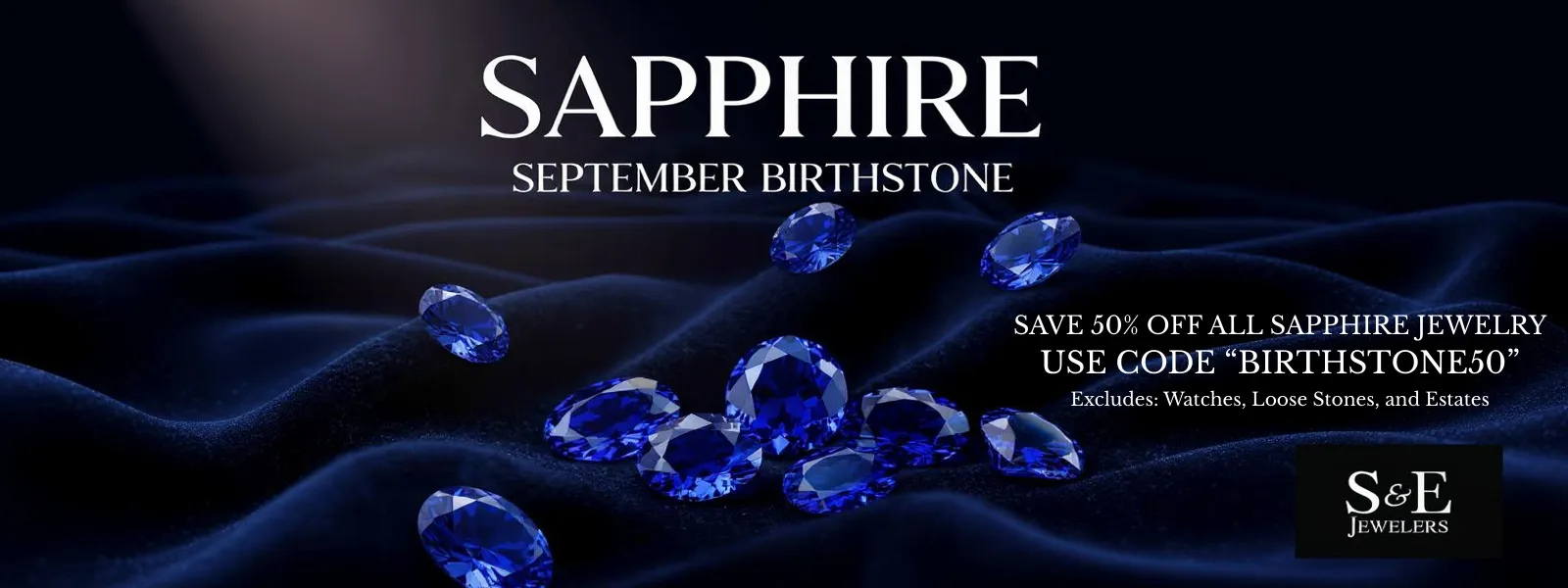 Sapphire gemstones on dark fabric. Click to see Sapphire jewelry at S&E Jewelers in Depew.