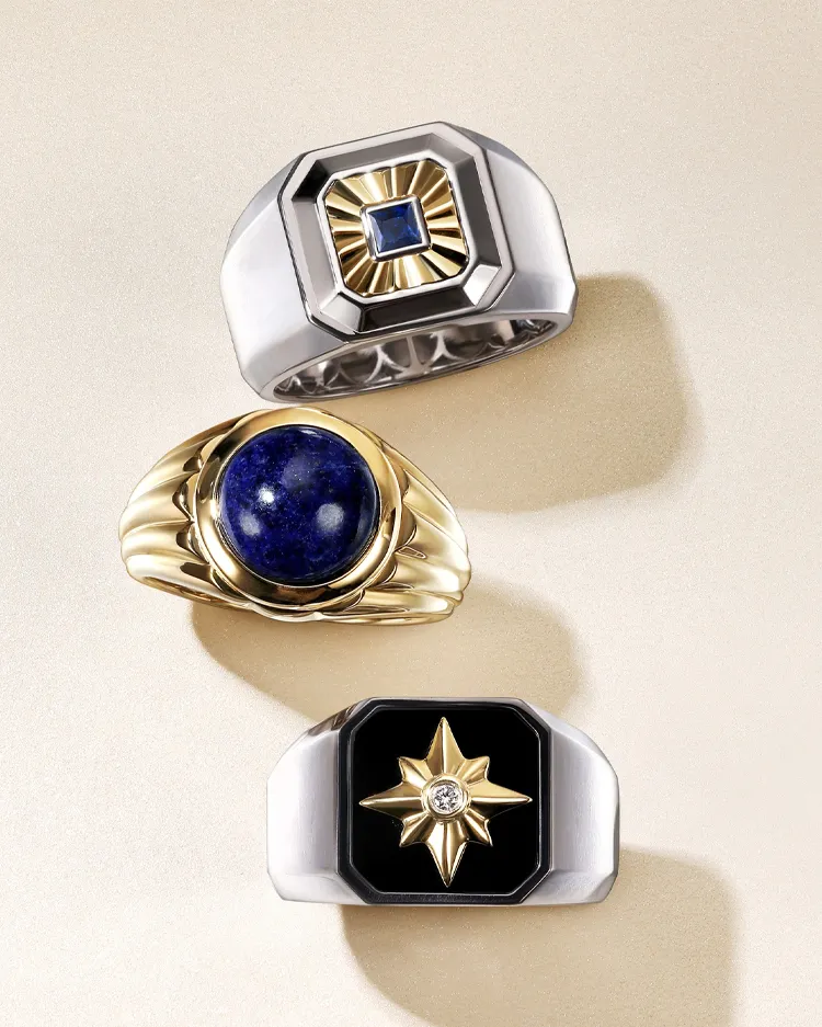 Three stylish men's rings featuring gemstones and unique designs, displayed elegantly on a light background.