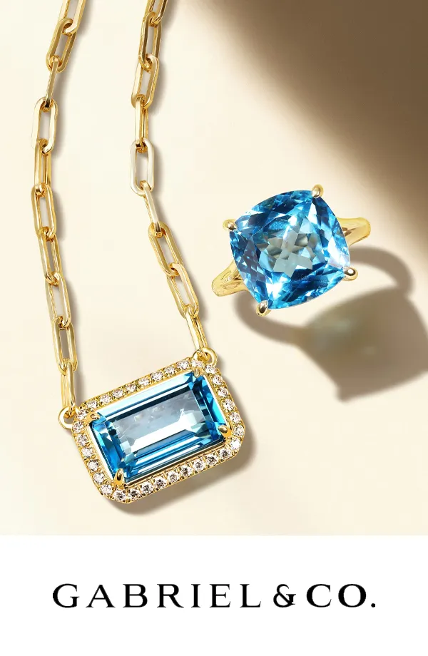 Gold necklace and ring featuring blue gemstones, displayed with the Gabriel & Co. logo.