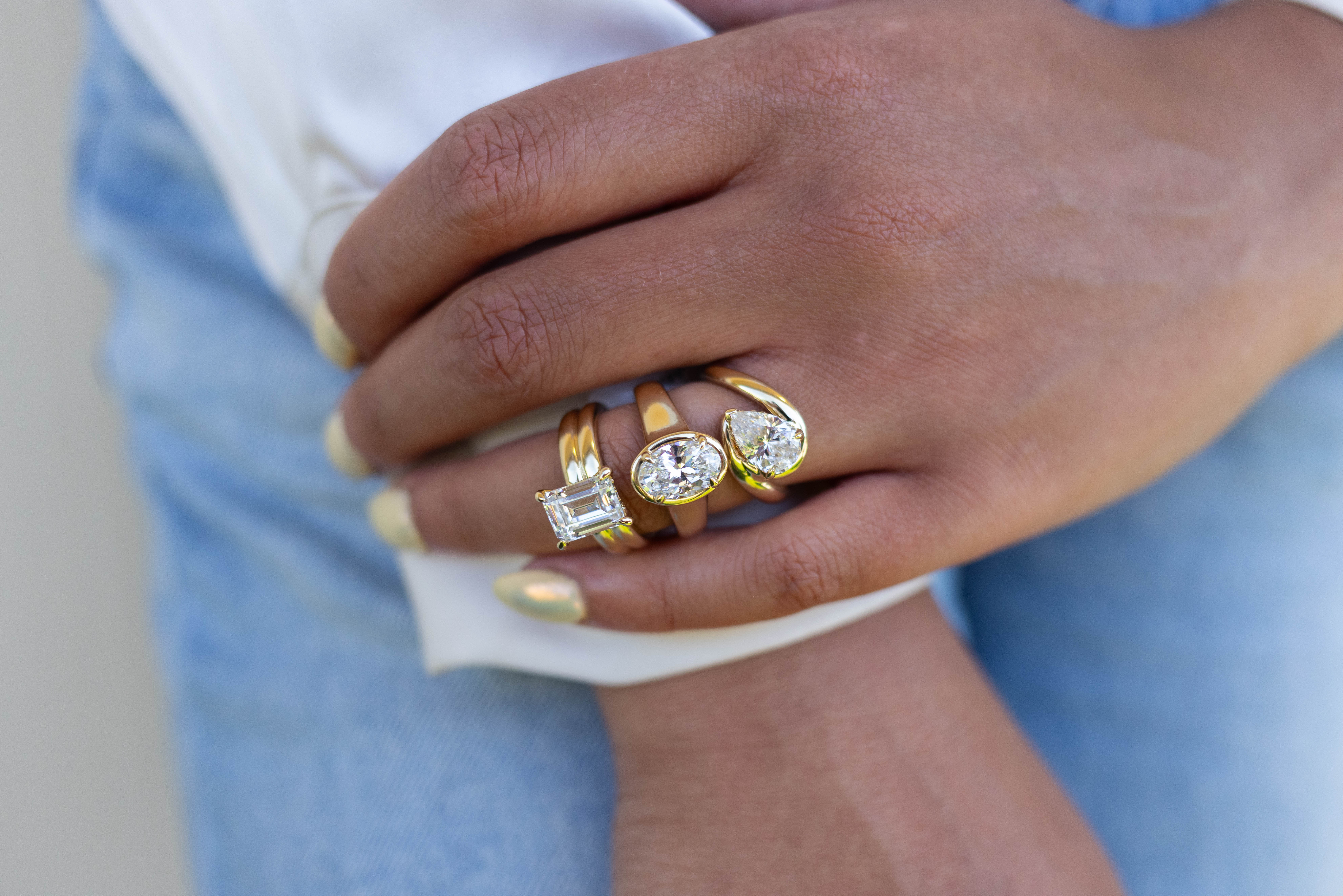 Three elegant diamond engagement rings displayed on a soft background. Explore Engagement Rings at Sather's Leading Jewelers.