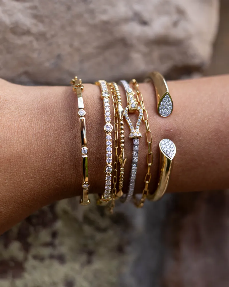 Silver flower ring with sparkling diamonds on a hand, showcasing fine jewelry. Click to Shop Now at Sather's Leading Jewelers.