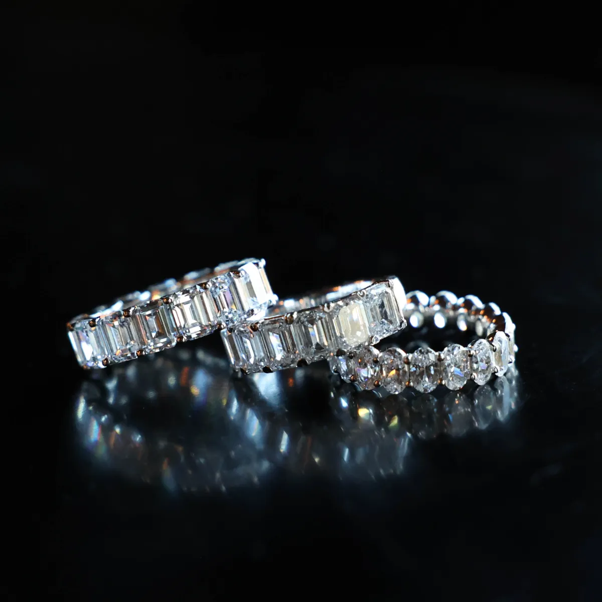 Three elegant silver anniversary bands with sparkling diamonds, showcasing luxury. Click to explore more at Sather's Leading Jew