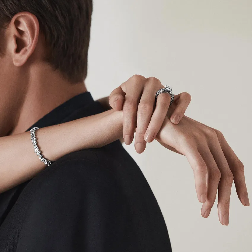 Elegant hands showcasing diamond bracelets, perfect for engagement or special occasions.