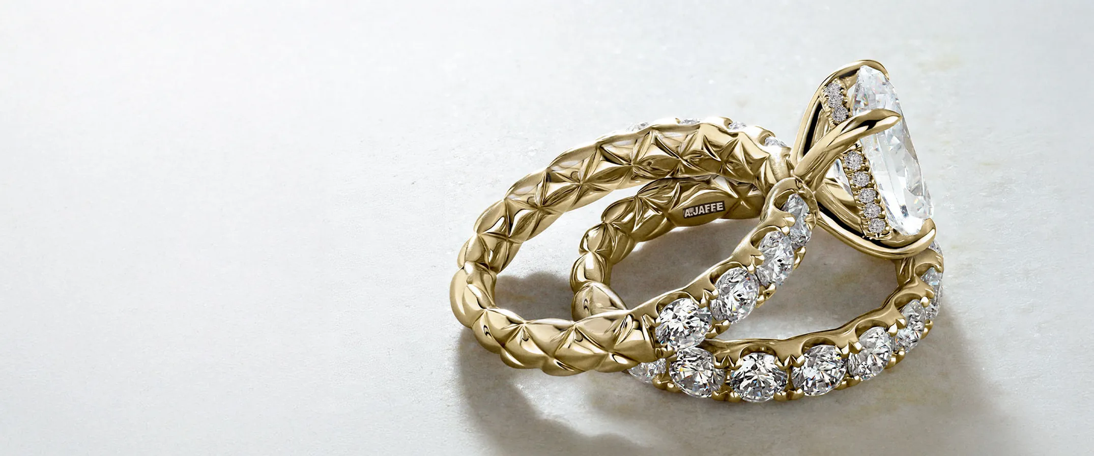 Elegant A. Jaffe gold engagement and wedding rings with diamonds.