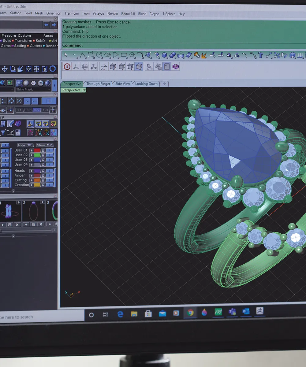 3D jewelry design software displaying a ring with a large blue gemstone and smaller surrounding gems.