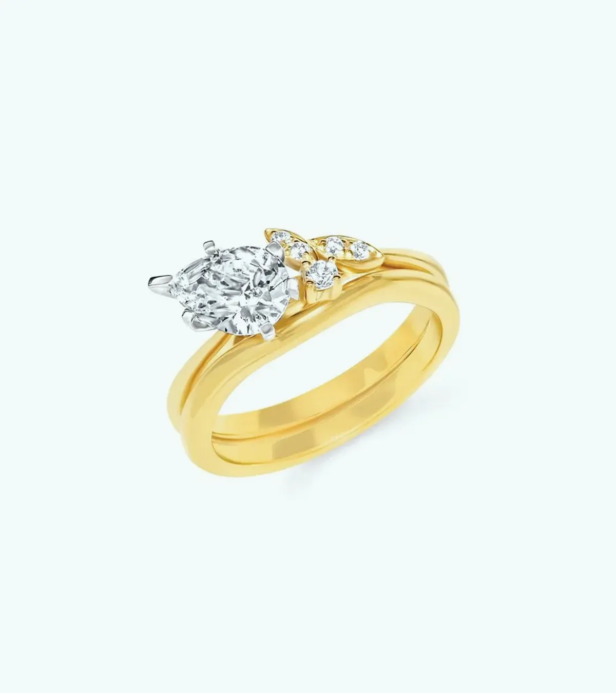 A gold engagement ring with a pear-shaped diamond and smaller accent diamonds.