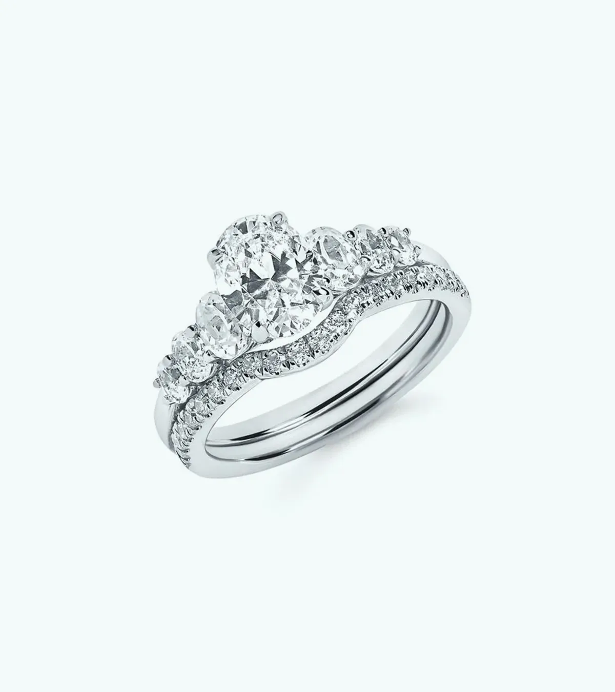 Diamond engagement ring set with multiple stones on a light background.