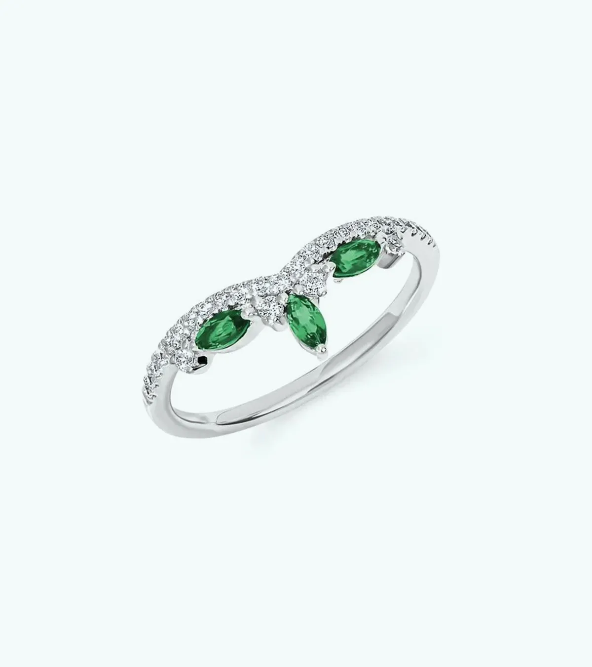 A silver ring with green gemstones and small diamonds in a leaf-like design.