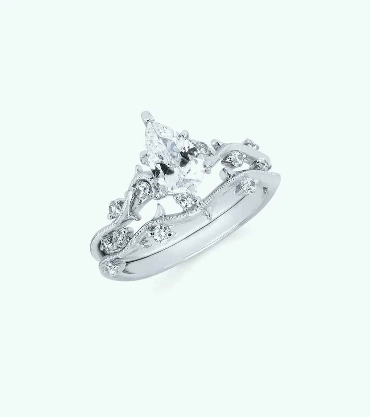 Elegant silver engagement ring with a marquise diamond and intricate vine design.