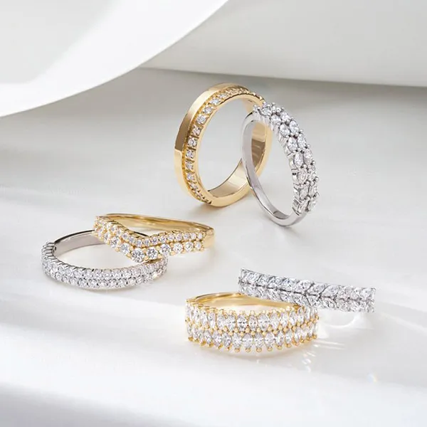 Five elegant women's wedding bands in gold and silver, featuring sparkling diamonds. Shop now at Sharbuno Jewelers, Inc.